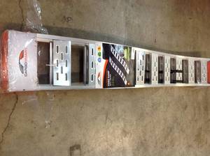 lot 112 image: CargoSmart 12 in. W x 90 in. L 1500 lb. Capacity Aluminum Fixed S-Curve Ramp with Treads (2-Pack) not used whit small damage please review the pictures