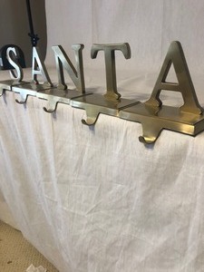 lot 203 image: BRASS S A N T A CHRISTMAS STOCKING HANGERS