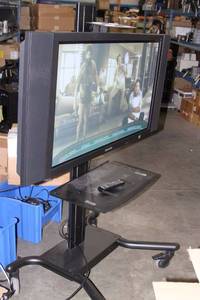 lot 91 image: Samsung 42 Flat Panel Plasma Display  Monitor with Audio Speakers Remote AND ROLLING STAND  CART