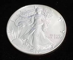 lot 58 image: 1987 AMERICAN SILVER EAGLE 1 TROY OZ. .999 FINE SILVER DOLLAR