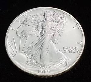 lot 66 image: 1989 AMERICAN SILVER EAGLE 1 TROY OZ. .999 FINE SILVER DOLLAR