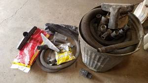 lot 55 image: Barrell full of Assorted Shop Vac Hoses and Attachments