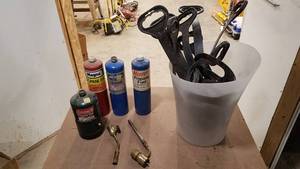 lot 377 image: (4) Cans of Propane and (2) Torch Tips  Bucket of Extension Cord Carriers