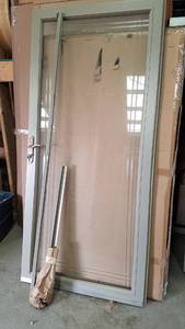 lot 443 image: 36 Glass Tan Storm Door W Frame and Lockset