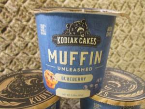 lot 131 image: 10 Kodiak Cakes Blueberry Muffin Un...