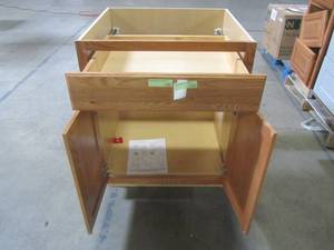 lot 304 image: Hampton Assembled 27x34.5x24 in. Base Kitchen Cabinet with Ball-Bearing Drawer Glides in Medium Oak KB27-MO