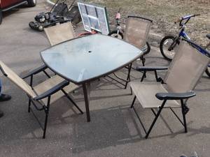 lot 15 image: Glass Top Patio Table & 4-Folding Chairs (1-Ripped Seam)