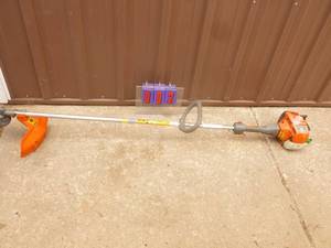 Husquvarna 2 cycle weed trimmer. Tested & works. Throttle is sticky. As shown.
