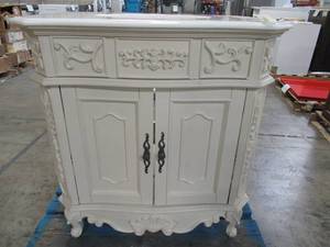 lot 216 image: Home Decorators Collection 2-Door Antique Looking Vanity Cabinet in Cream With Stone Top (Cracked Back RH Corner), Approximate 32 12 X 22 X 35 Tall.