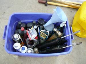 lot 69 image: Automotive Oil Brake fluid, Receiver Hitch and ball. Funnel, 2 Grease Guns, Grease, Gear lube, Tote