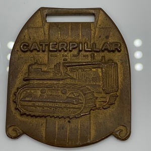 lot 12 image: Caterpillar Tractor Brand Vintage Watch Fob