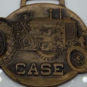 lot 4 image: CASE Tractor Watch Fob