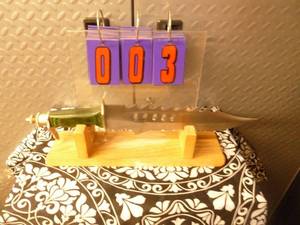 Large Bowie style knife with display stand. Appears like new. As shown.