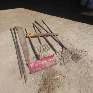lot 32 image: Lot of Pry Bars, Saws, Rake, Pitchforks, Snow Shovel