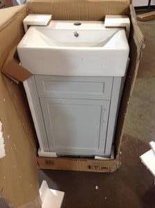 lot 25 image: Pallet of assorted bathroom items toilets and Arvesen 18 in. W x 12 in. D Vanity in Dove Grey with Ceramic Vanity Top in White with White Sink ( customer returns )