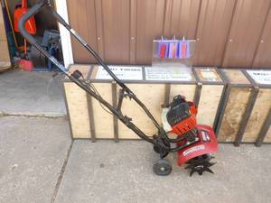 lot 18 image: Craftsman 2 cycle Mini Tiller. Has spark but couldnt get started. As shown.
