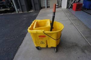 lot 51 image: Rubbermaid Brand Commercial Wave Brake Wheeled Janitors Mop Bucket