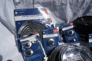 lot 21 image: GE Brand Electric Range Element & Gas Oven Control Knobs and Oven Drip Pans