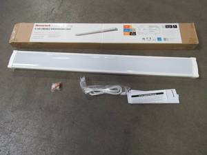 lot 222 image: Honeywell 4 ft. White 4000 Lumens 4000K Integrated LED Linkable Wraparound Light, KT140N843100 - END CAP CRACKED