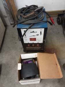 lot 82 image: Miller Thunder Bolt 225 Volt Welder With Helmet & Rods