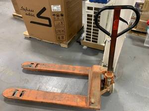 Used orange Pallet Jack.