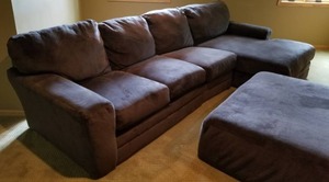 lot 1 image: Deep Gray Sectional and Ottoman by Jackson