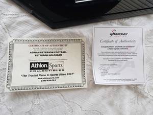 lot 7 image: Autographed ADRIAN PETERSON Football  In Case, Certified