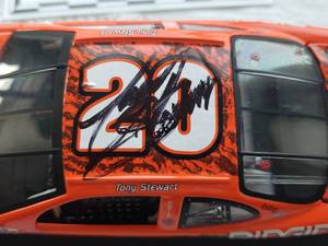 lot 92 image: Autographed TONY STEWART 124 Scale Die Cast 2001 Home Depot Jurassic Park #20 Pontiac