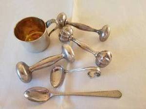 lot 117 image: Sterling Silver Collection of Baby Rattles, Spoons and Cup