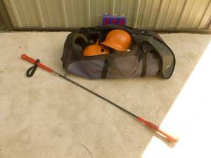 lot 35 image: Large bag with batting helmets & hit stick. As shown.
