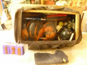 lot 125 image: Bag of batting helmets & softballs. As shown.