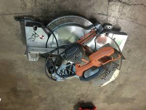 lot 200 image: RIDGID 15 Amp Corded 12 in. Dual Bevel Sliding Miter saw in working condition. Missing blade and bag. USED