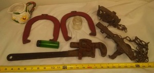 lot 74 image: Vintage horse shoes, traps, wrench & more.