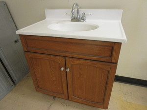lot 819 image: BATHROOM VANITY, WITH PRICE PFISTER FAUCET, OAK CABINET