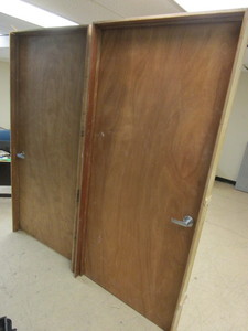 lot 822 image: WOOD DOORS, IN CASINGS, WITH BRUSHED CHROME HANDLES