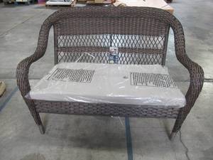 lot 419 image: Hampton Bay Brown Wicker Outdoor Stack Loveseat with Beige Cushion - 1 Leg Unraveled.