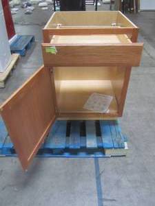 lot 305 image: Hampton Bay Assembled 24x34.5x24 in. Base Kitchen Cabinet with Ball-Bearing Drawer Glides in Medium Oak KB24-MO