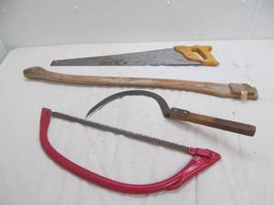 lot 108 image: hand saws, reaper, ax handle