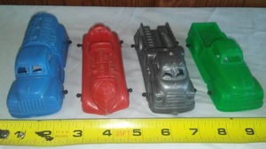 lot 24 image: 4 Plastic Vintage Trucks and Race Car.