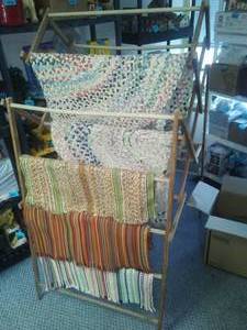 lot 117 image: Rugs and 3 vintage drying racks.