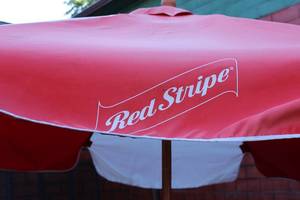 lot 64 image: Red & White Red Stripe Patio Umbrella