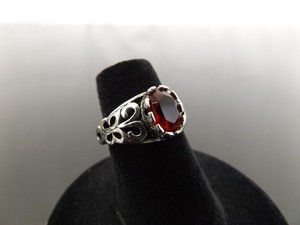 lot 61 image: .925 Sterling Silver Oval Cut Ruby Crystal Scrolled Ring Size 5