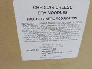 lot 128 image: 23 lb. Box of Cheddar Cheese Soy Ne...