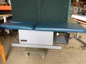 lot 83 image: Hill Laboratories Foot Activated Electric Power Adjustable Hi  Low Treatment Chiropractic Table - Nice Condition No Tears To Upholstery Though Is Coming A Little Loose Underneath