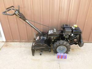 lot 1 image: Craftsman 18 Dual Direction rear tine rototiller. 208cc. Unit appears like new. Tested & works. As shown. THIS ITEM HAS A RESERVE.
