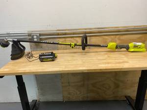 lot 33 image: RYOBI 40-Volt Lithium-Ion Brushless Electric Cordless Attachment Capable String Trimmer 4.0 Ah Battery and Charger Included