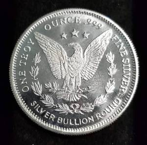 lot 34 image: 1 TROY OZ. .999 FINE SILVER MORGAN DOLLAR DESIGN