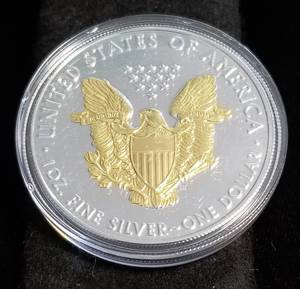 lot 55 image: 2019 AMERICAN SILVER EAGLE 1 TROY OZ. .999 FINE SILVER GOLD ENHANCED IN AIRTITE