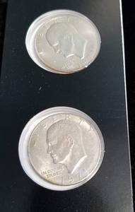 lot 11-A image: 2 EISENHOWER DOLLARS IN BLACK PACKAGING