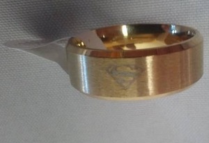lot 150 image: Superman Emblem ring - gold colored Size 10.